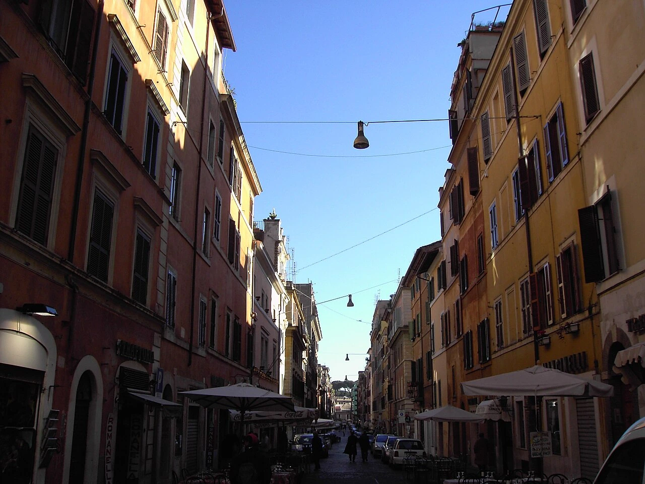 Location view along Borgo Pio, with colourful façades and café terraces