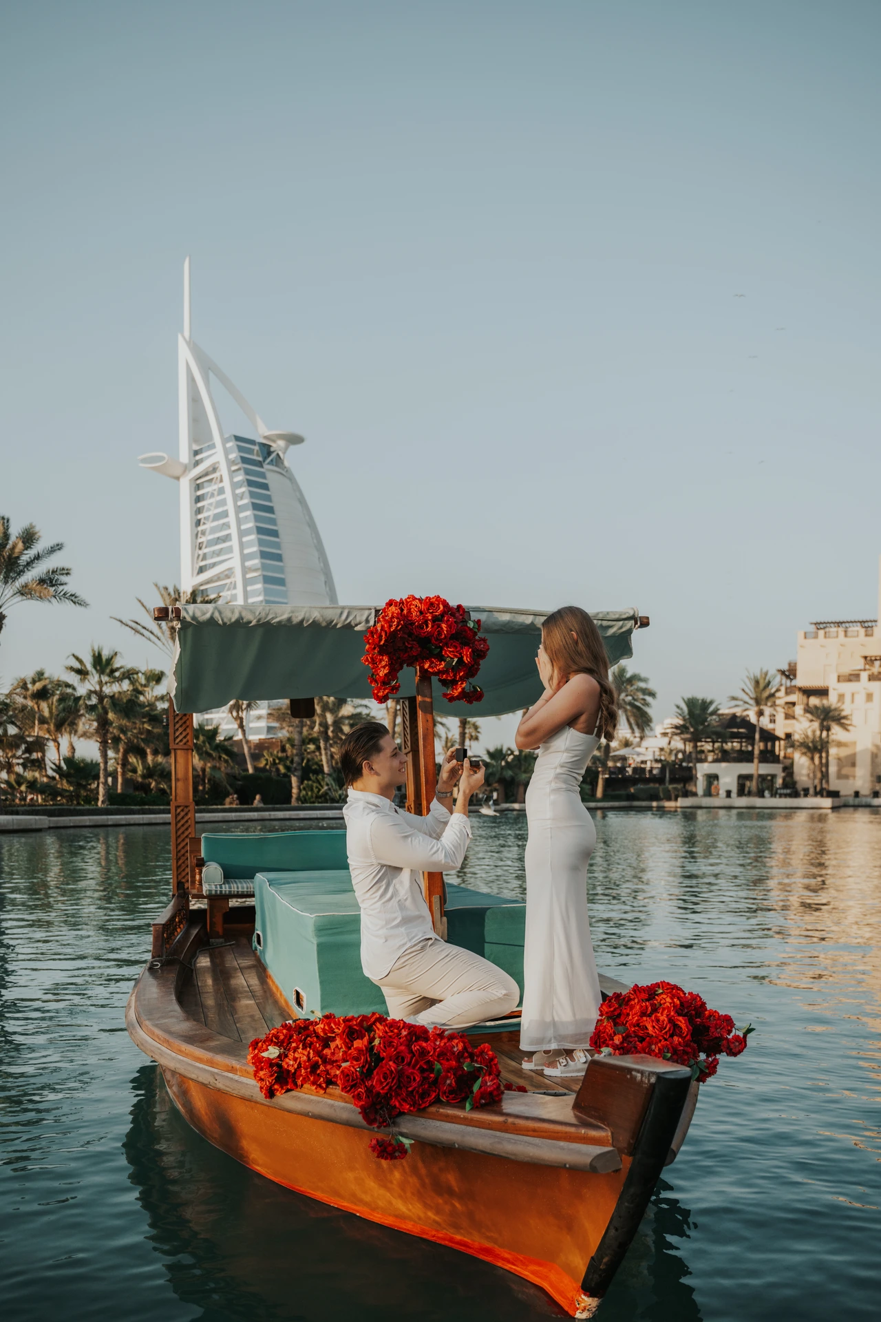 A surprise proposal on an abra at Souk Madinat as the groom-to-be kneels and presents the ring.