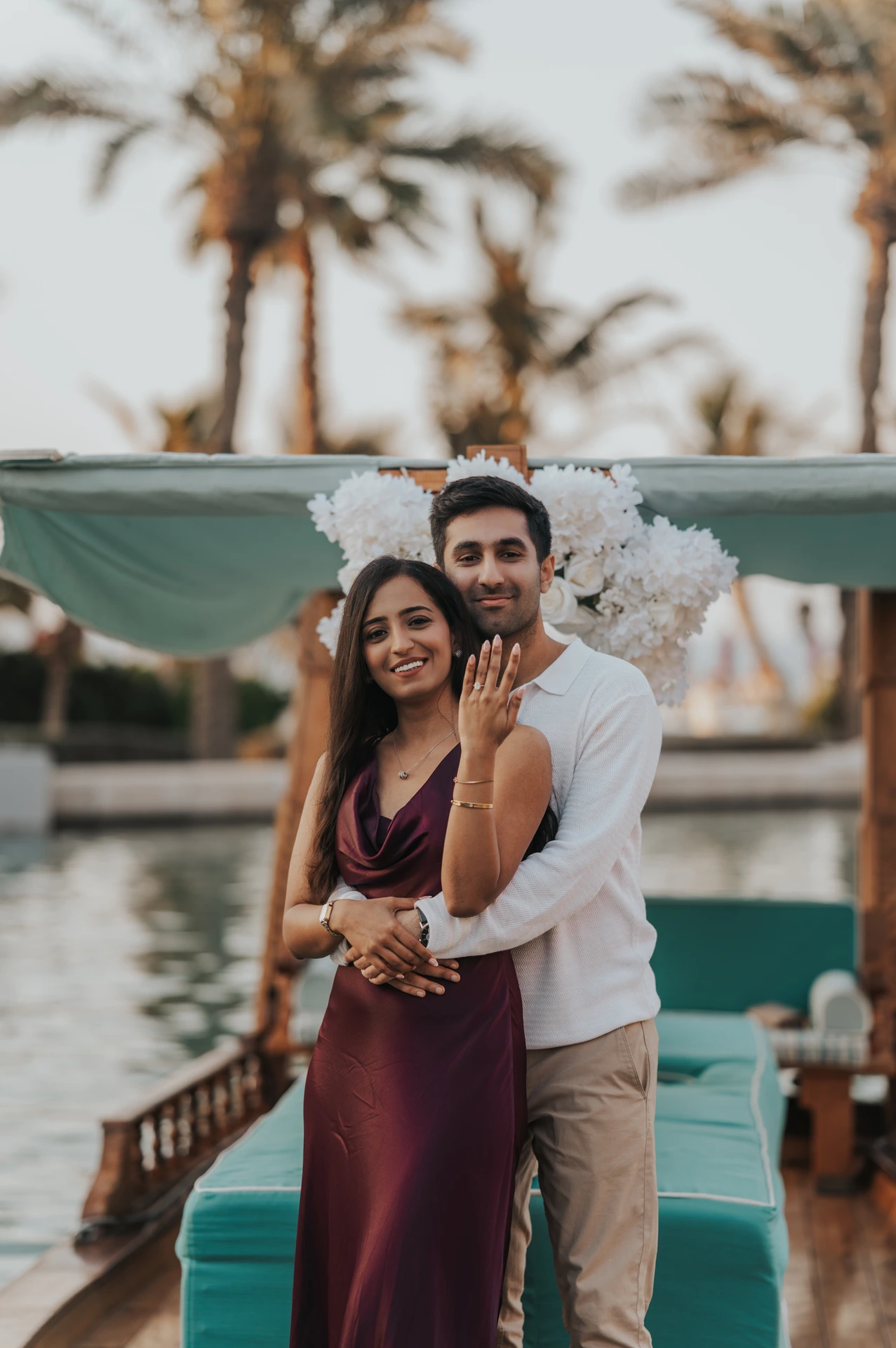 A couple poses on an abra as the bride-to-be shows her engagement ring during a Souk Madinat proposal shoot.