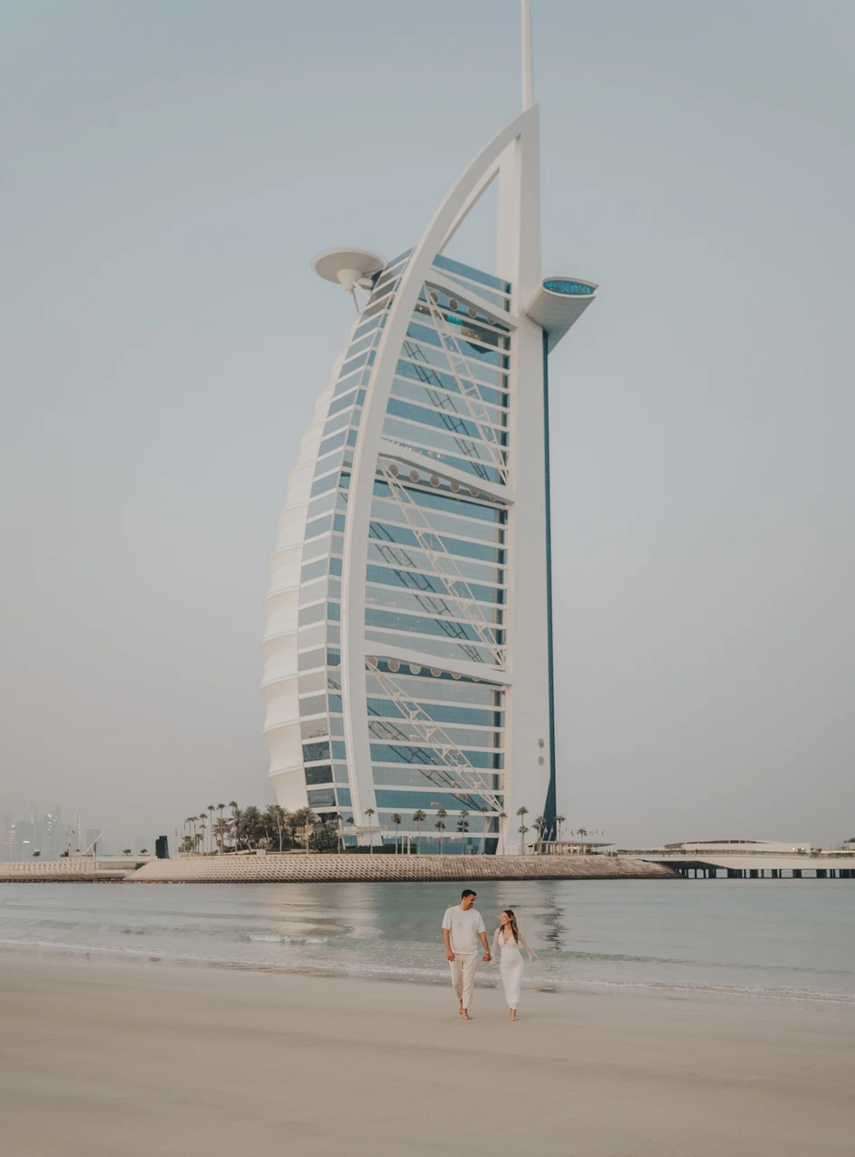 Couple photoshoot dubai costs - Burj Al Arab landmark frame A clean view of Burj Al Arab from the beach, used as an iconic Dubai landmark backdrop in couple photoshoots.