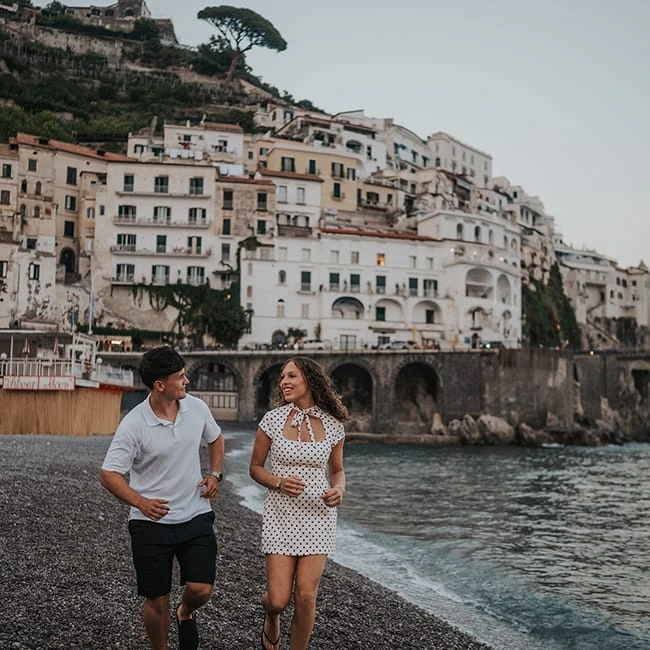 Engagement couple walking by the sea in Amalfi during a photoshoot