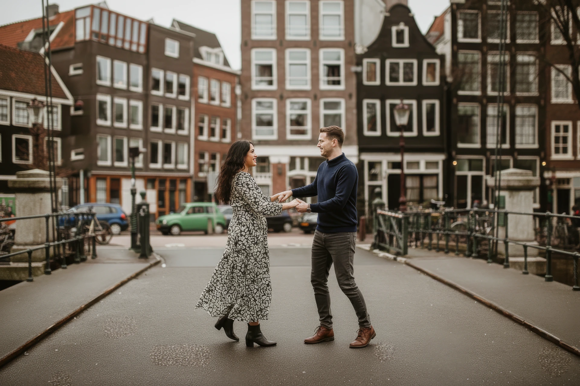 A couple posing as if they are dancing during their photoshoot in Amsterdam