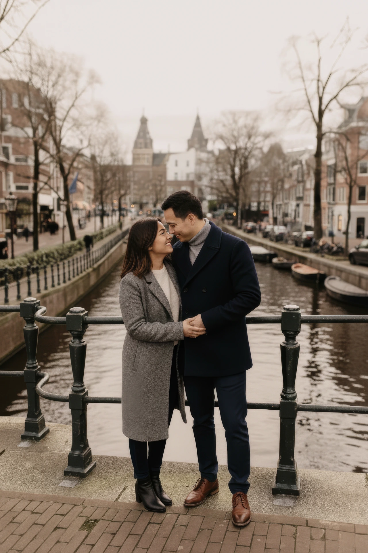 A couple posing by a bridge over the canals in Amsterdam