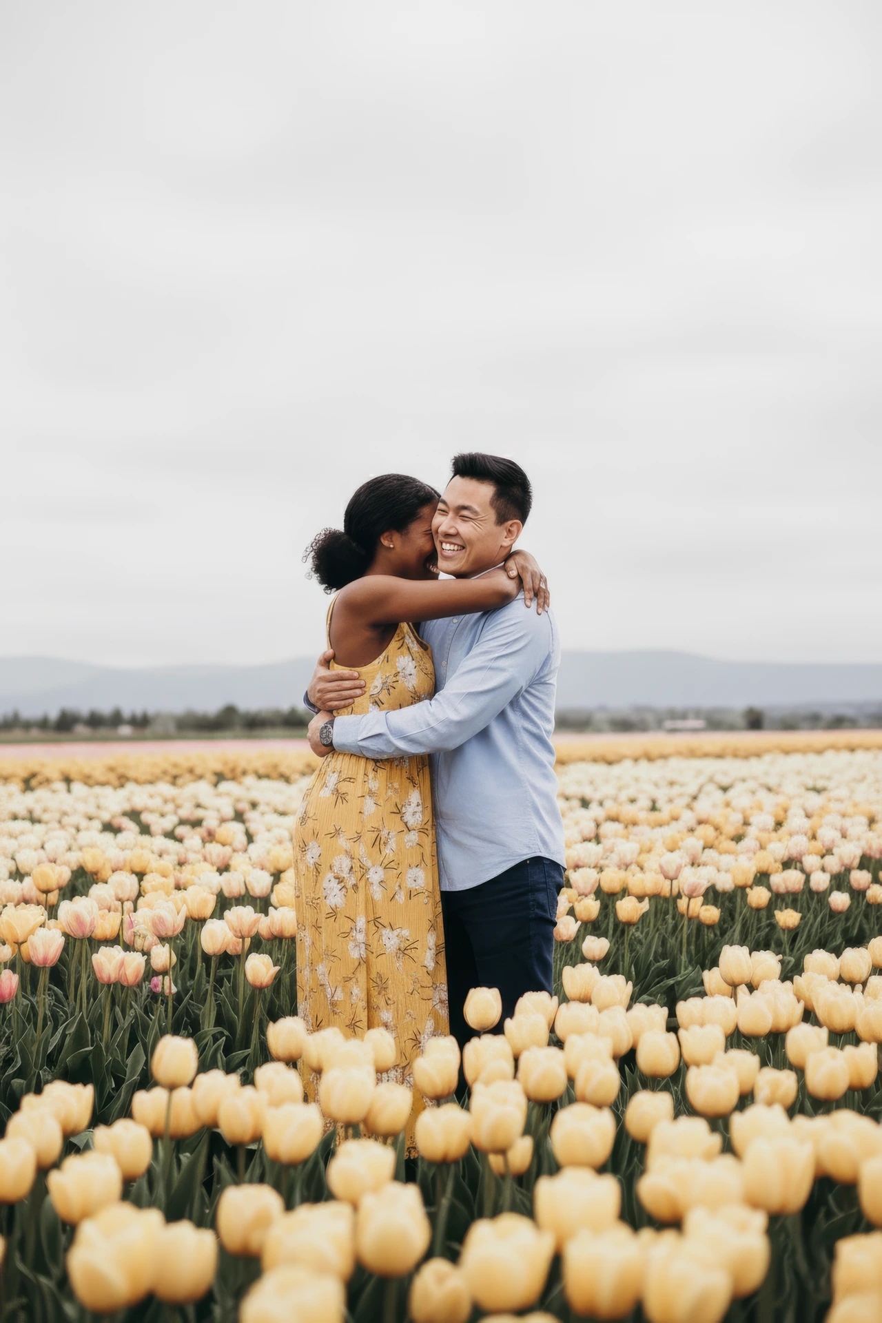 A couple being photographed during their marriage proposal in Amsterdam tulip fields