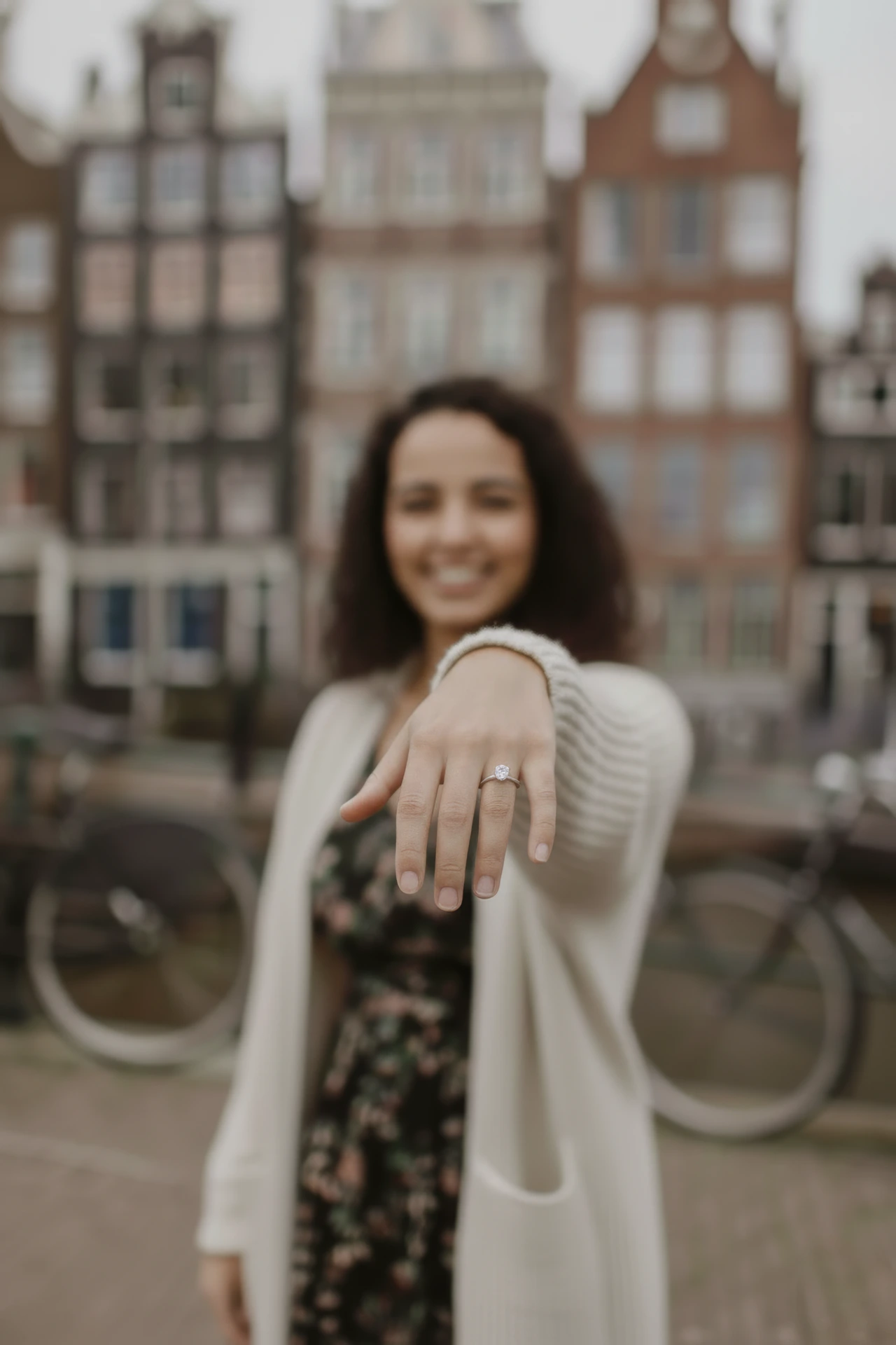 Proposal photographer Amsterdam A woman showing her diamond ring posing for a proposal photographer in Amsterdam.