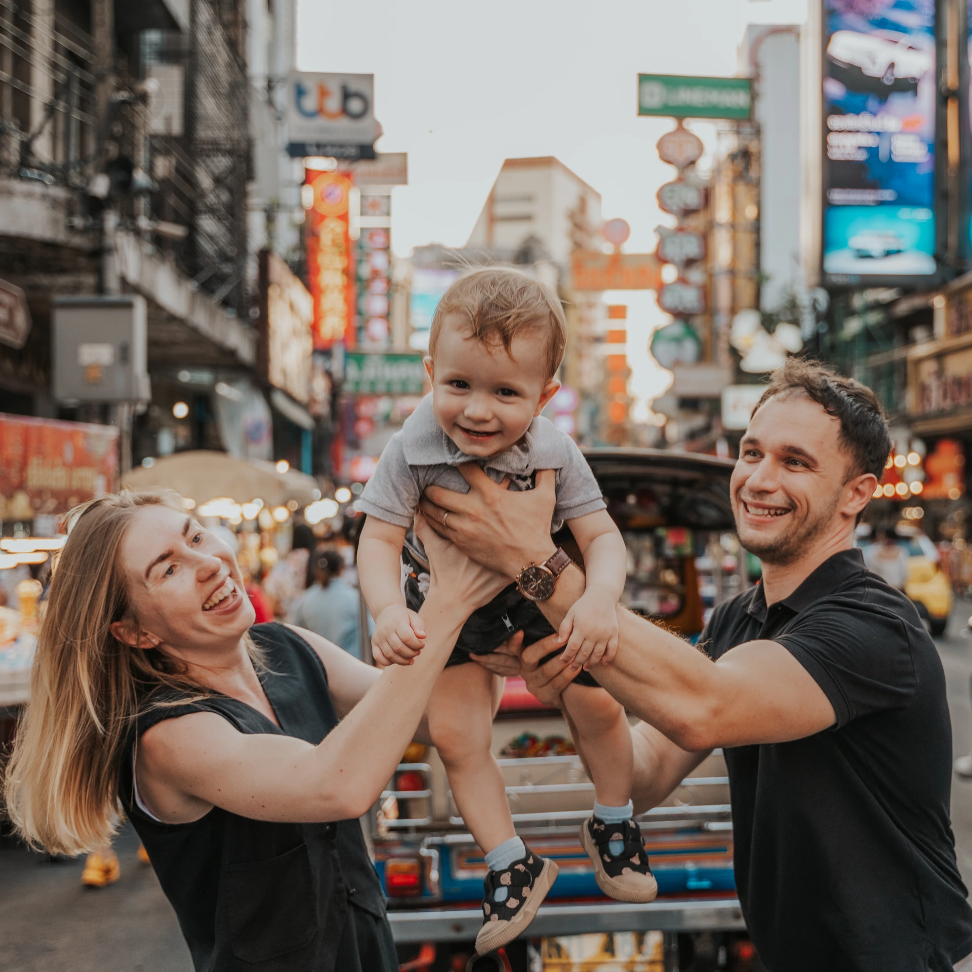 Parents holding their child during a Bangkok Chinatown photoshoot
