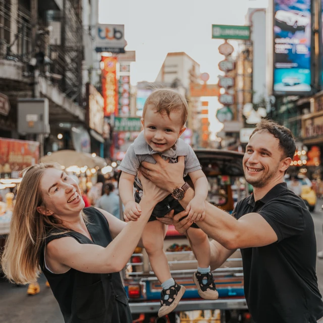 Parents holding their child during a Bangkok Chinatown photoshoot