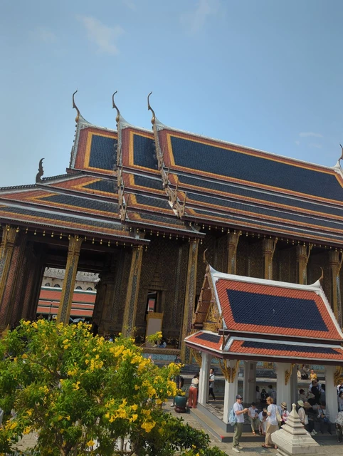 Decorated palace buildings and visitors at Bangkok’s Grand Palace