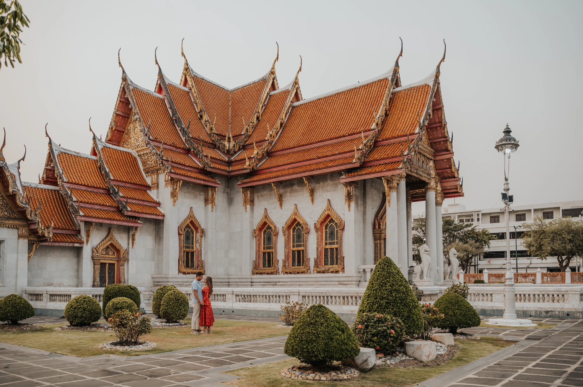 Woman in a red dress in the grounds of Wat Benchamabophit in Bangkok