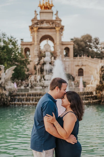Close portraits beside the fountain pool | Barcelona family photoshoot The parents standing close together in front of the fountain during their family photoshoot in Barcelona.