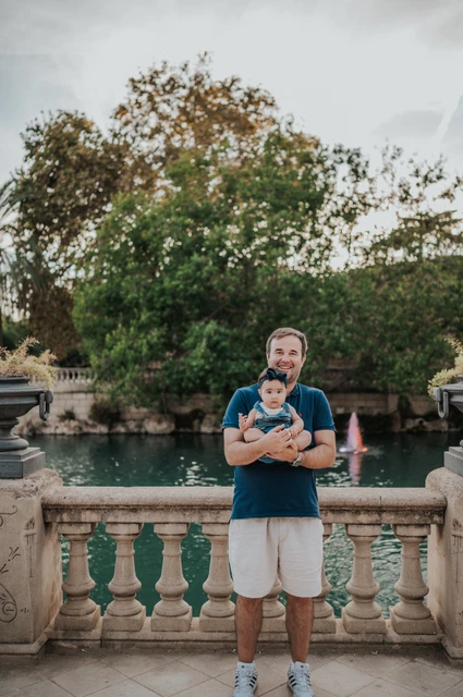 Father and child by the balustrade | Barcelona family photoshoot The father holding his child beside the stone balustrade during their family photoshoot in Barcelona.