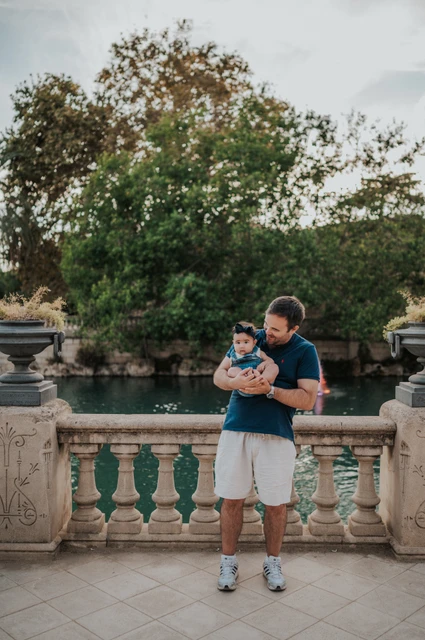 Father and child by the balustrade | Barcelona family photoshoot The father holding his child beside the stone balustrade during their family photoshoot in Barcelona.