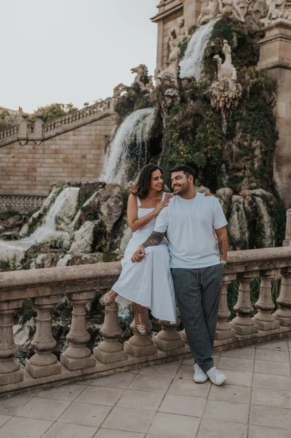 Portraits beside the waterfall balustrade | Barcelona engagement photoshoot The couple posing by the carved balustrade with the waterfall and fountain architecture behind them during their engagement photoshoot in Barcelona.