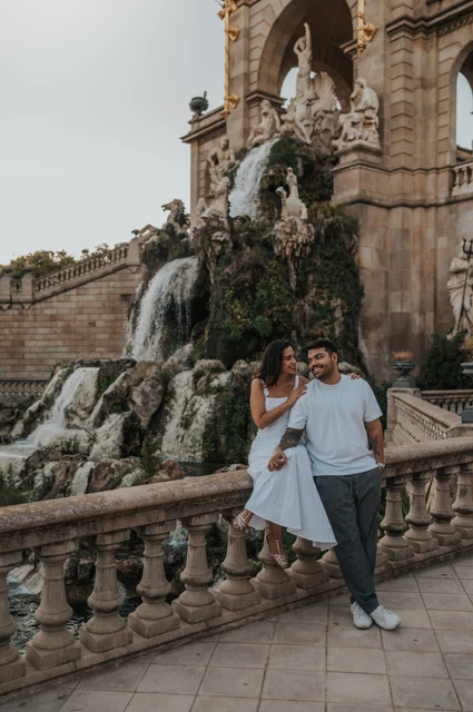 Portraits beside the waterfall balustrade | Barcelona engagement photoshoot The couple posing by the carved balustrade with the waterfall and fountain architecture behind them during their engagement photoshoot in Barcelona.