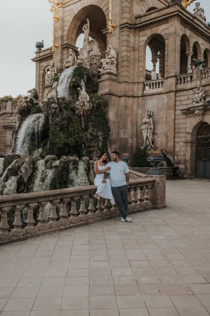 Portraits beside the waterfall balustrade | Barcelona engagement photoshoot The couple posing by the carved balustrade with the waterfall and fountain architecture behind them during their engagement photoshoot in Barcelona.
