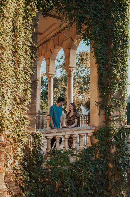Portraits framed by ivy and stone arches | Barcelona couple photoshoot The couple framed by ivy and stone arches above a carved balustrade during their couple photoshoot in Barcelona.