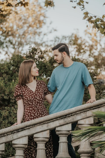A close moment on the staircase | Barcelona couple photoshoot A closer portrait of the couple leaning towards each other behind the staircase balustrade during their couple photoshoot in Barcelona.
