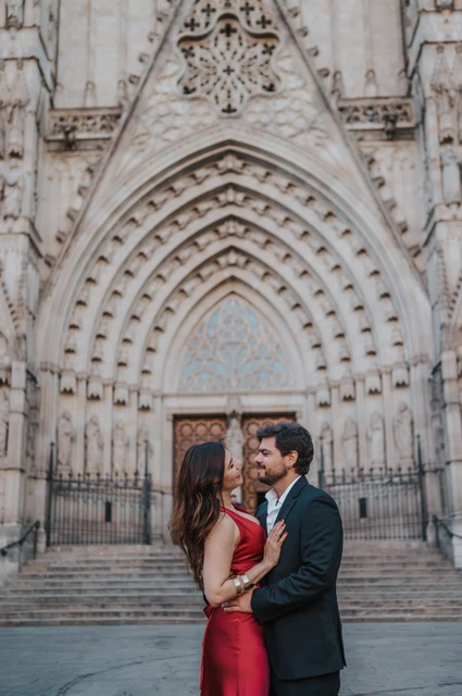 Engagement portraits in front of Barcelona Cathedral | Barcelona engagement photoshoot The couple standing close together in front of Barcelona Cathedral’s carved Gothic entrance during their engagement photoshoot in Barcelona.