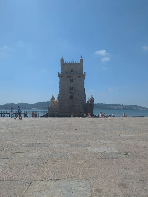Belém Tower rising beside the Tagus from the open riverfront in Lisbon