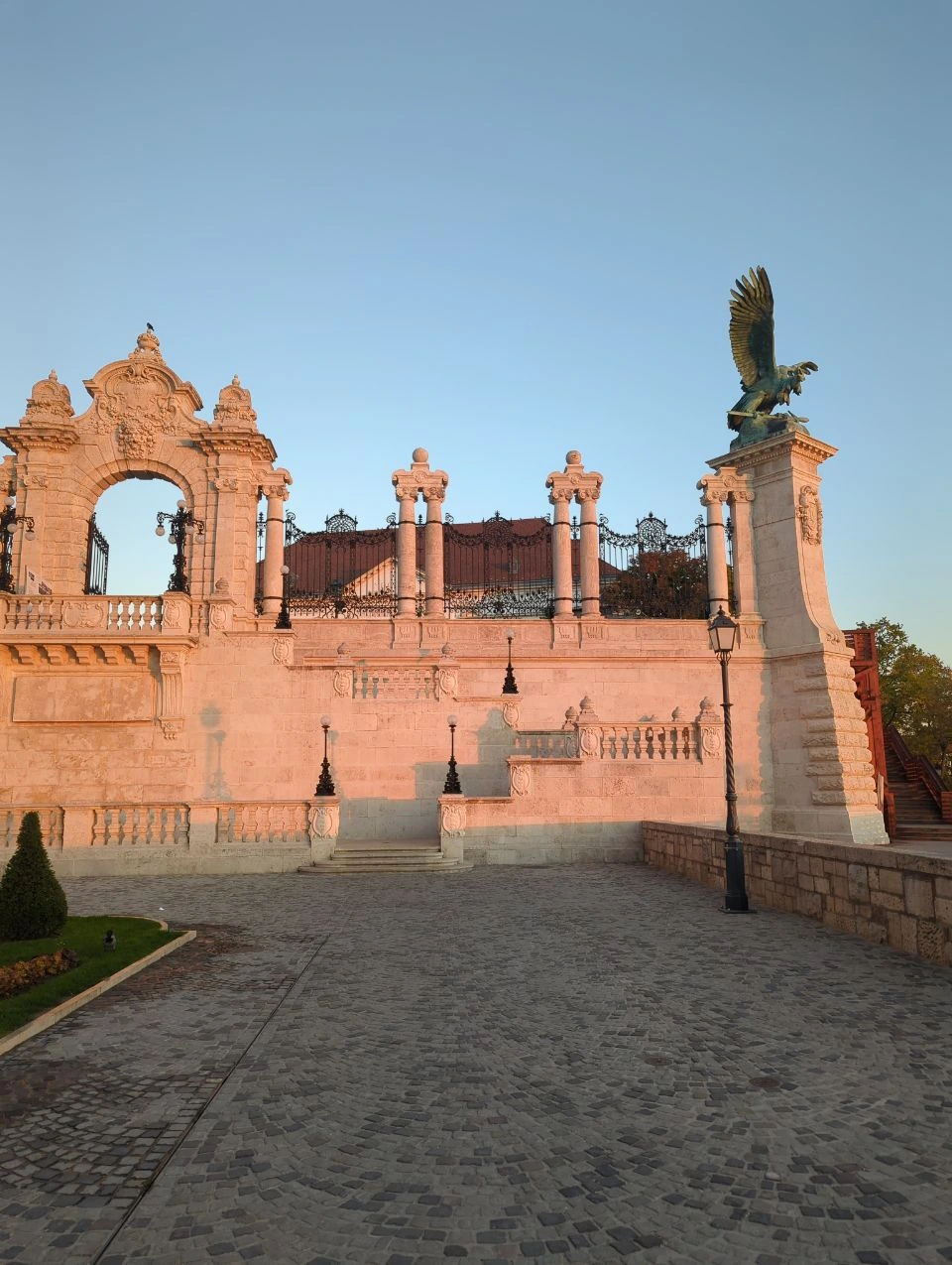 Habsburg Gate and Turul at Buda Castle Habsburg Gate, wrought-iron fence and Turul statue in warm morning light