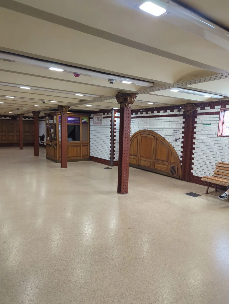 Opera metro station concourse Tiled Opera M1 metro station concourse with iron columns and wooden doors