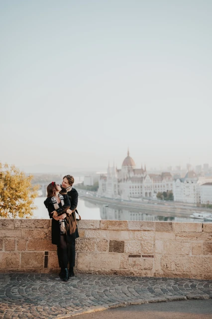 Couple photoshoot in Budapest with a Buda Castle platform portrait Couple standing close together and facing the camera on a Buda Castle platform during their Budapest photoshoot