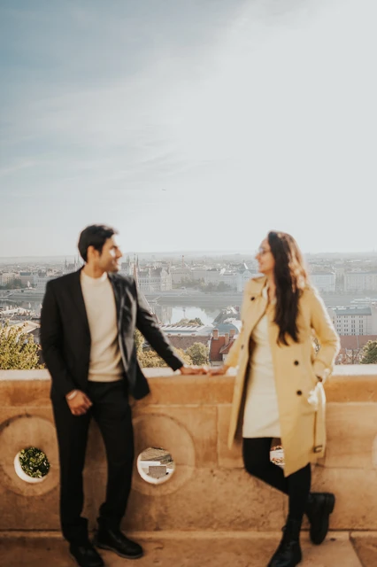 Couple photoshoot in Budapest at the Fisherman's Bastion viewpoint Couple holding hands beside the Fisherman's Bastion balustrade during their morning photoshoot in Budapest