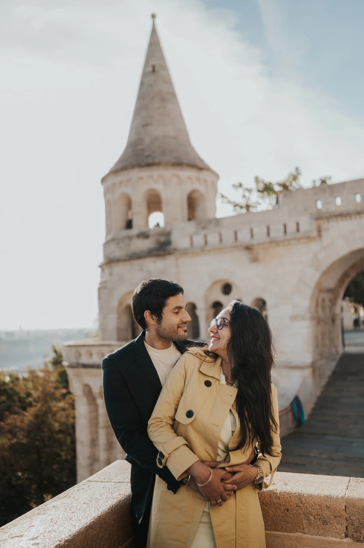 Close portrait of a couple embracing beside a stone balustrade at Fisherman's Bastion during their photoshoot in Budapest