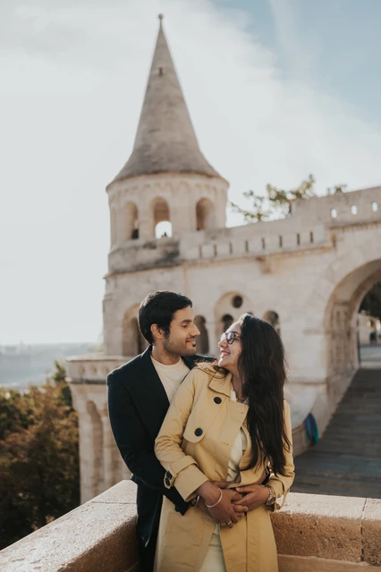 Close couple photoshoot in Budapest beside the Fisherman's Bastion balustrade Close portrait of a couple embracing beside a stone balustrade at Fisherman's Bastion during their photoshoot in Budapest
