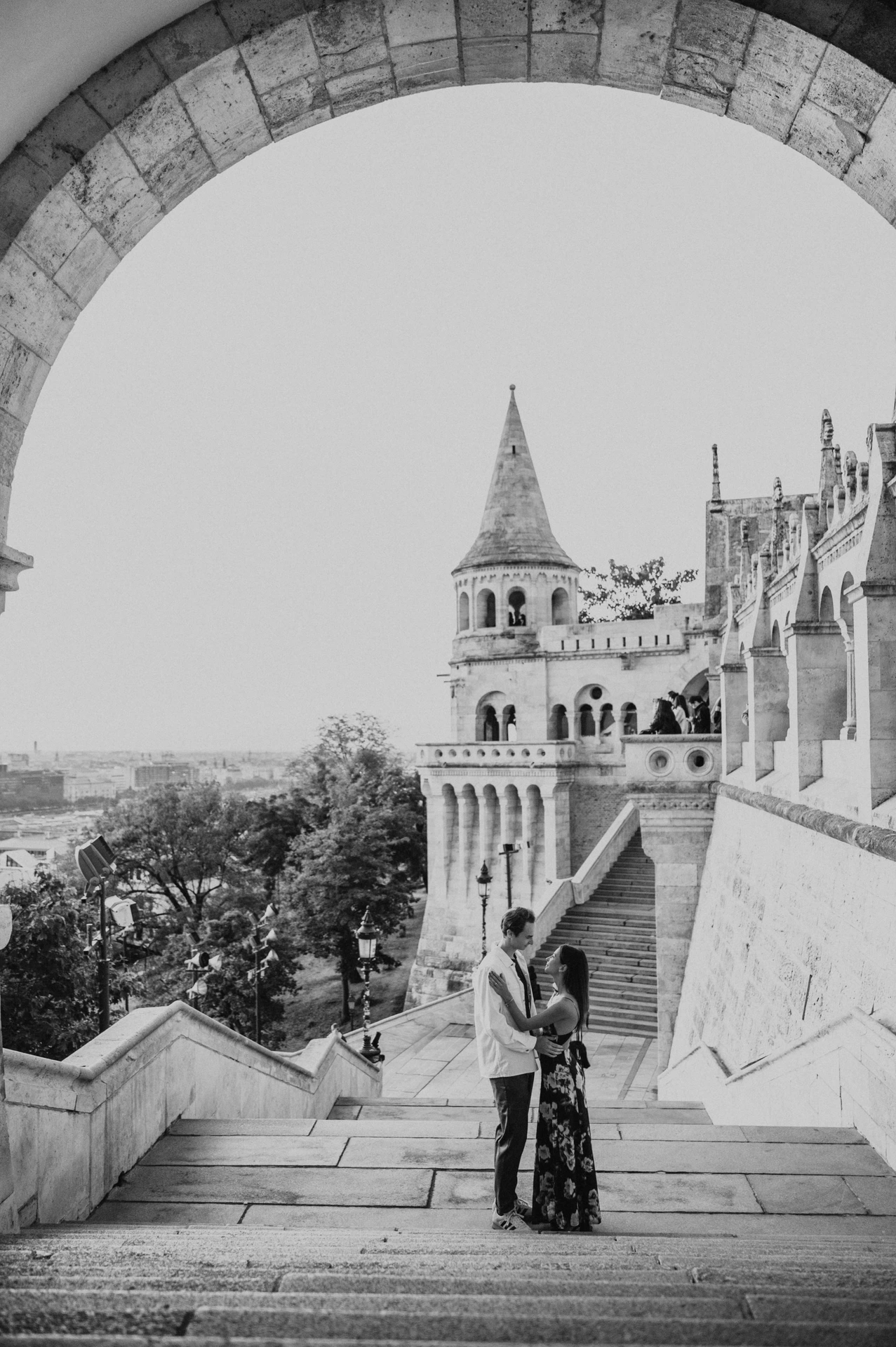 Black-and-white photograph of the couple together on the stone steps during their Budapest photoshoot at Fisherman’s Bastion.