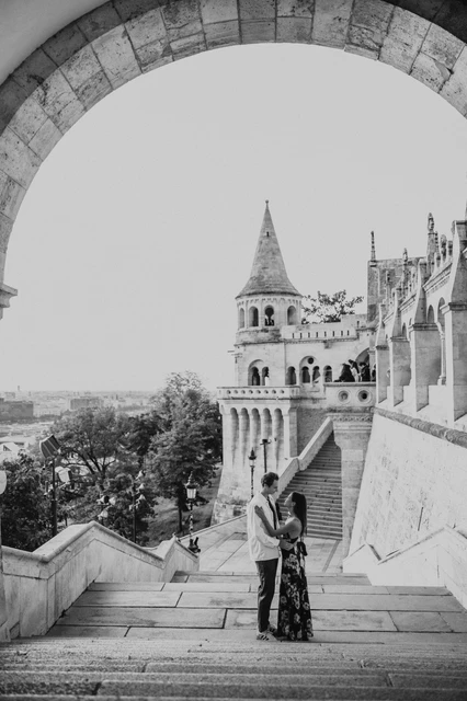 Black-and-white Budapest couple photoshoot on the stone staircase Black-and-white photograph of the couple together on the stone steps during their Budapest photoshoot at Fisherman’s Bastion.