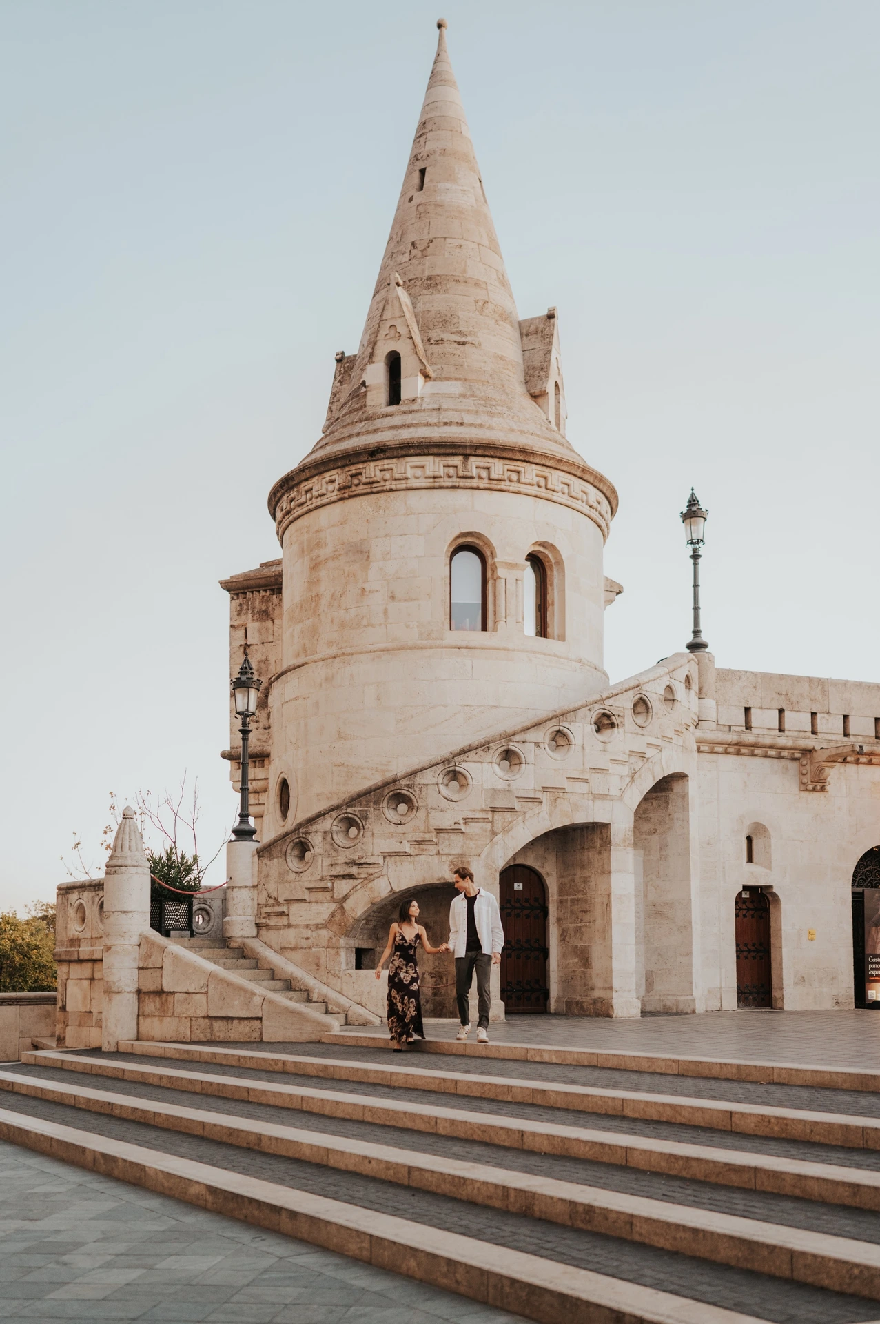 The couple together on the broad steps beside the arched walkway during their Budapest photoshoot at Fisherman’s Bastion.