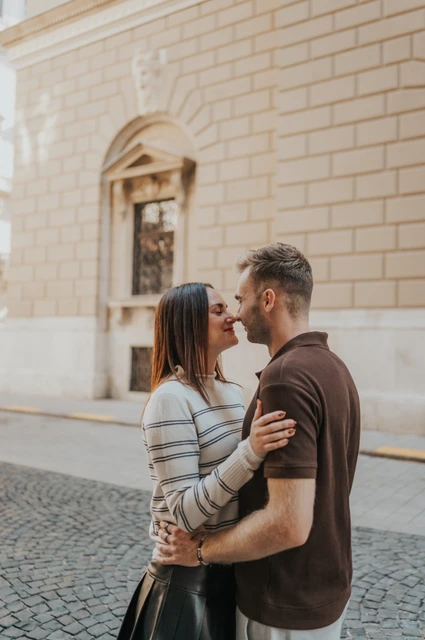 Budapest couple photoshoot: a close portrait on a cobbled street A closer portrait of the couple leaning towards each other on a cobbled street near the Opera during a couple photoshoot in Budapest.