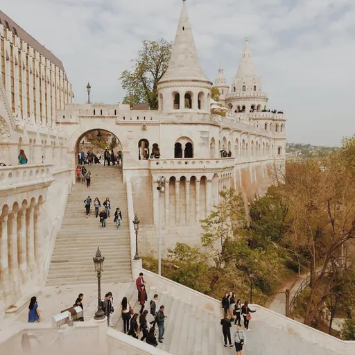Illuminated Széchenyi Chain Bridge over Danube River at dusk with moon in Budapest Hungary