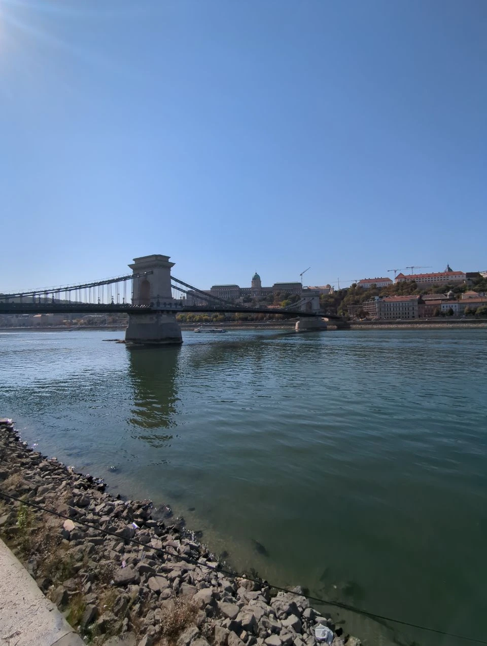 Chain Bridge from the Pest riverbank Chain Bridge and Buda Castle beyond the Danube from a rocky Pest-side riverbank