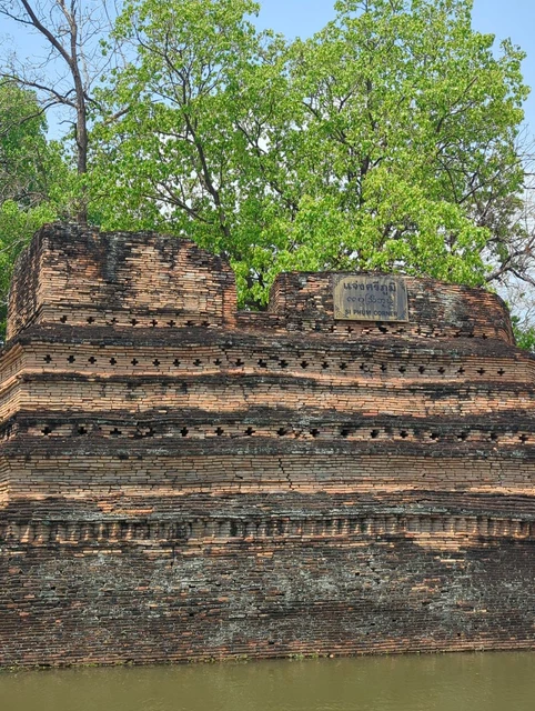Old brick city wall beside the moat in Chiang Mai