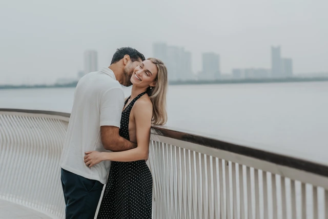 City engagement couple portrait by waterfront railing in Dubai