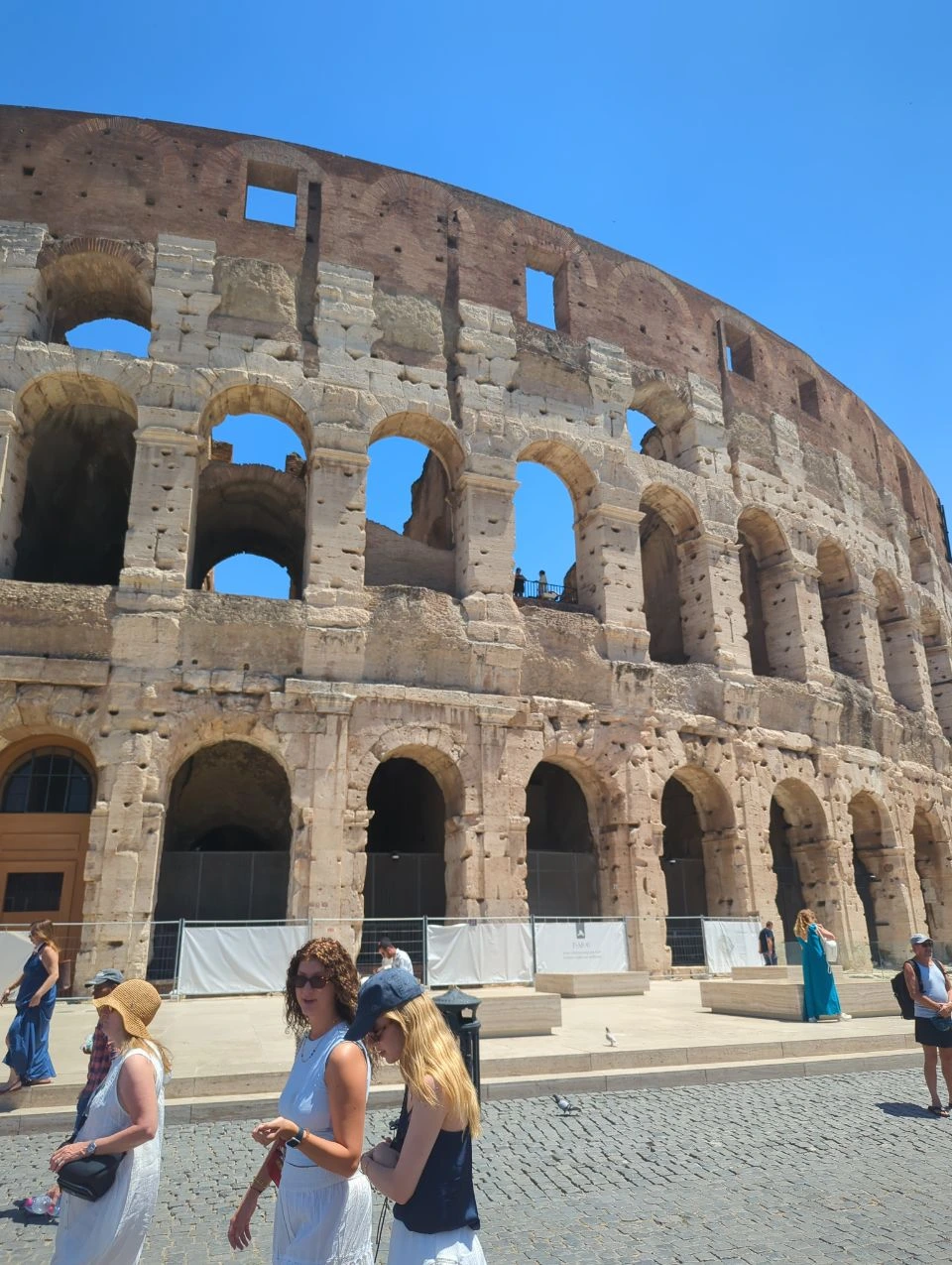 The Colosseum’s curved stone facade and repeating arches show the dramatic close-angle backdrop available for a Rome photoshoot.
