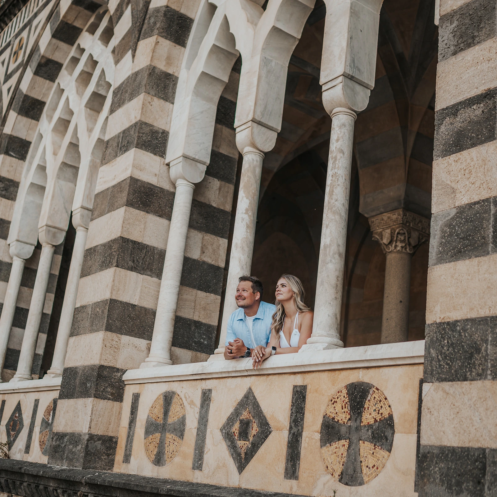 Couple beside the striped arches of Amalfi Cathedral