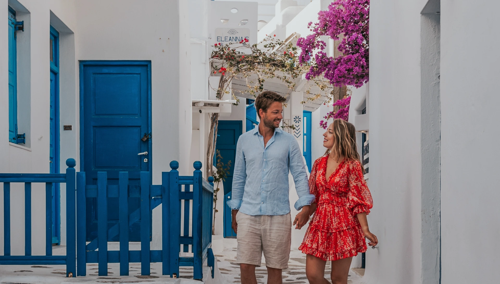 Couple framed by a white arch in the streets of Mykonos Town