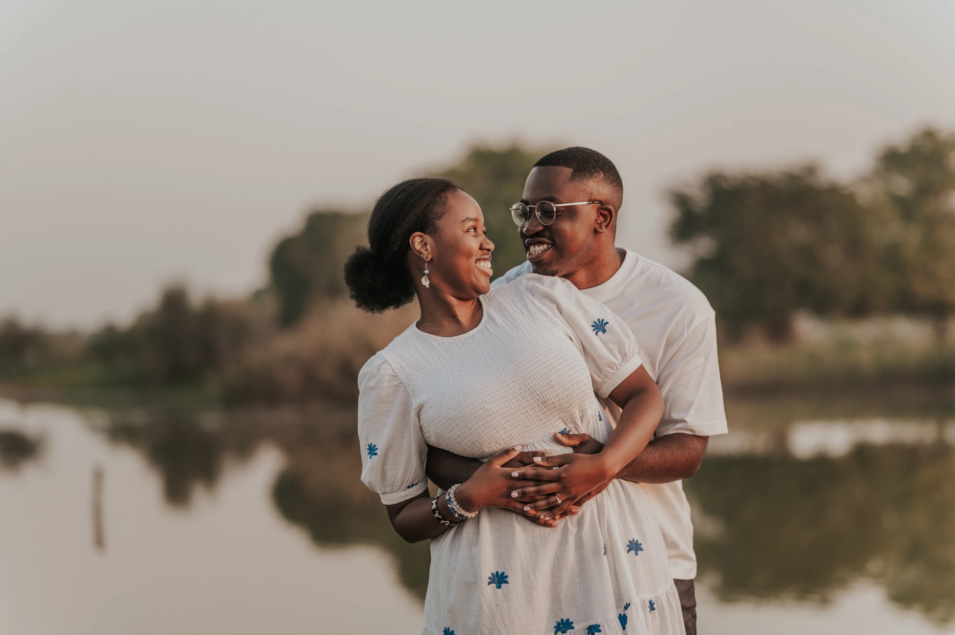 Dubai Couple Photoshoot - nature-inspired portrait A couple stands in a natural Dubai location during a couple photoshoot, using soft greenery and open space for relaxed connection-focused portraits.