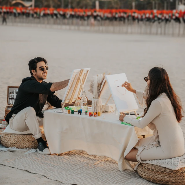 Dubai couple photoshoot Couple photoshoot with painting gear on the beach in Dubai