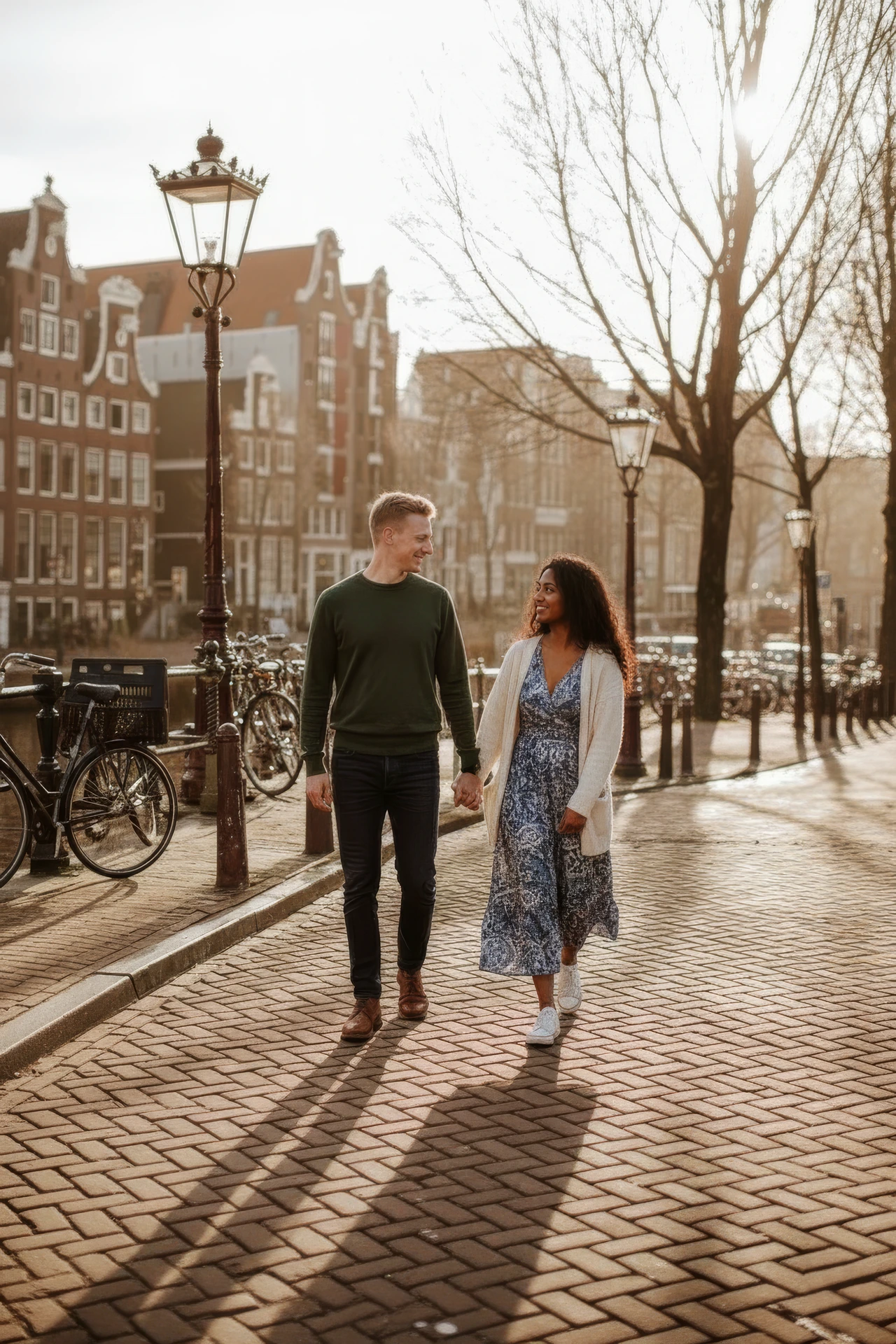 Couple walking beside an Amsterdam canal in warm evening light Couple walking beside an Amsterdam canal in warm evening light