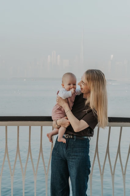 Mother holding baby at Creek Harbour Dubai waterfront