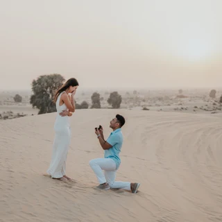 Couple proposing in the Dubai desert on a dune