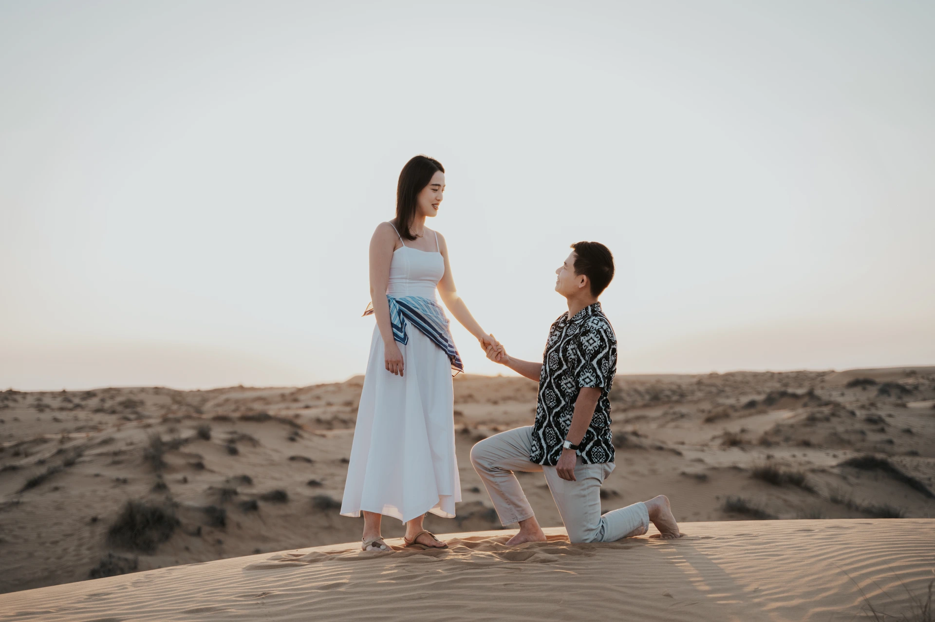 Desert proposal in Dubai with couple overlooking the desert