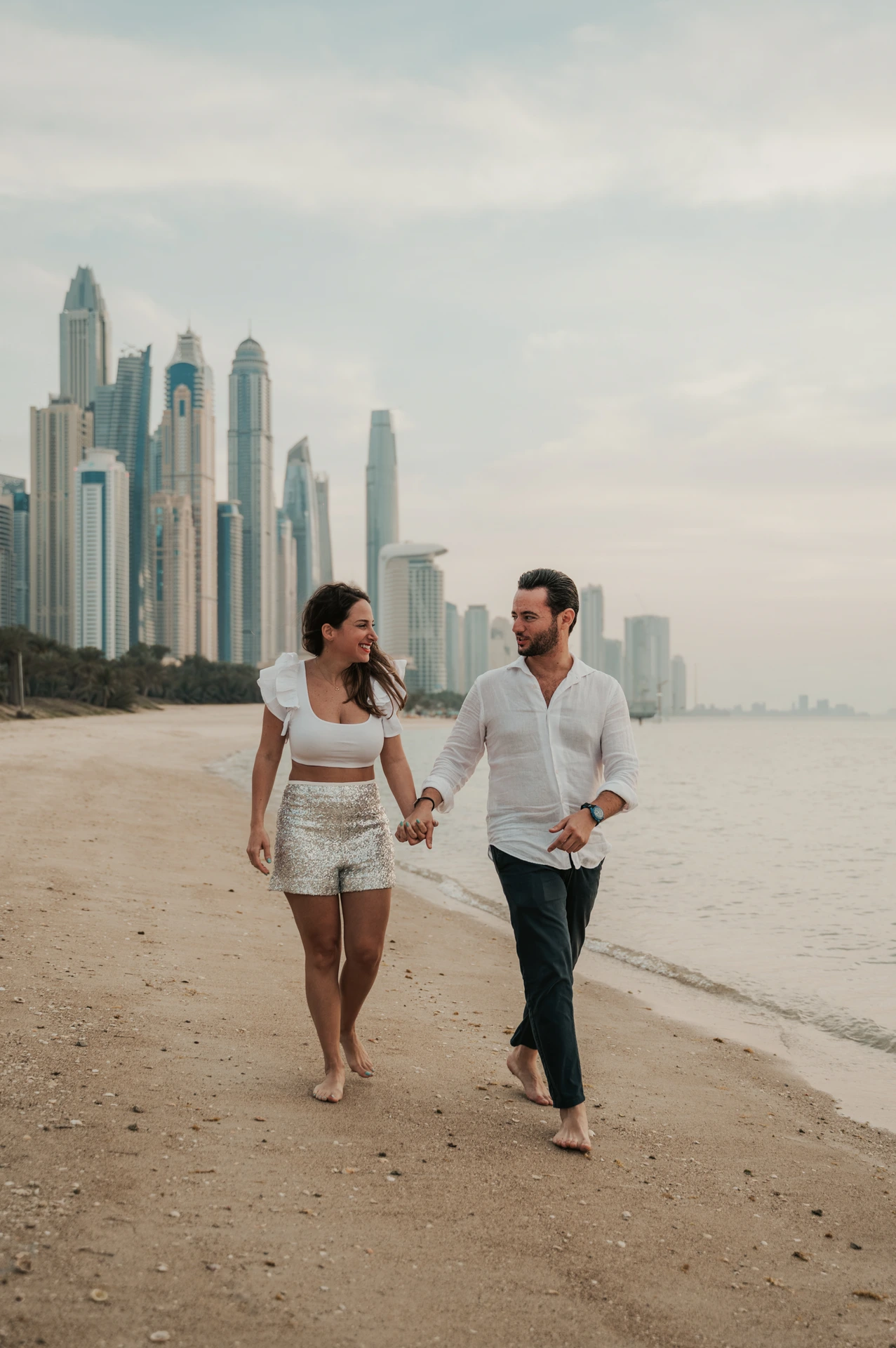 Dubai Engagement Photoshoot - Marina portrait An engaged couple is photographed with Dubai Marina in the background, creating a modern engagement photoshoot look with clean urban depth.