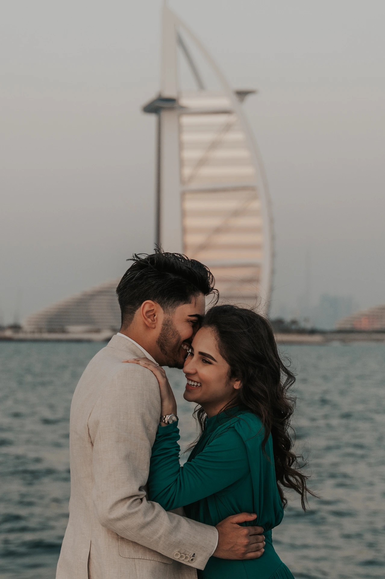 Dubai Engagement Photoshoot - boat session An engaged couple is photographed on a boat in Dubai during an engagement photoshoot, with open water and skyline context for destination storytelling.
