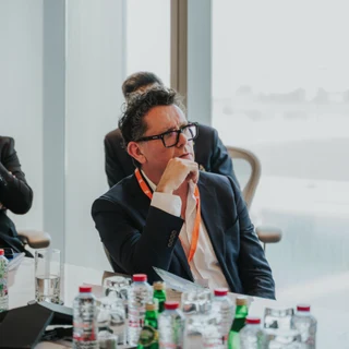 Business event in Dubai being captured by an event photographer whilst a person is listening to a speech