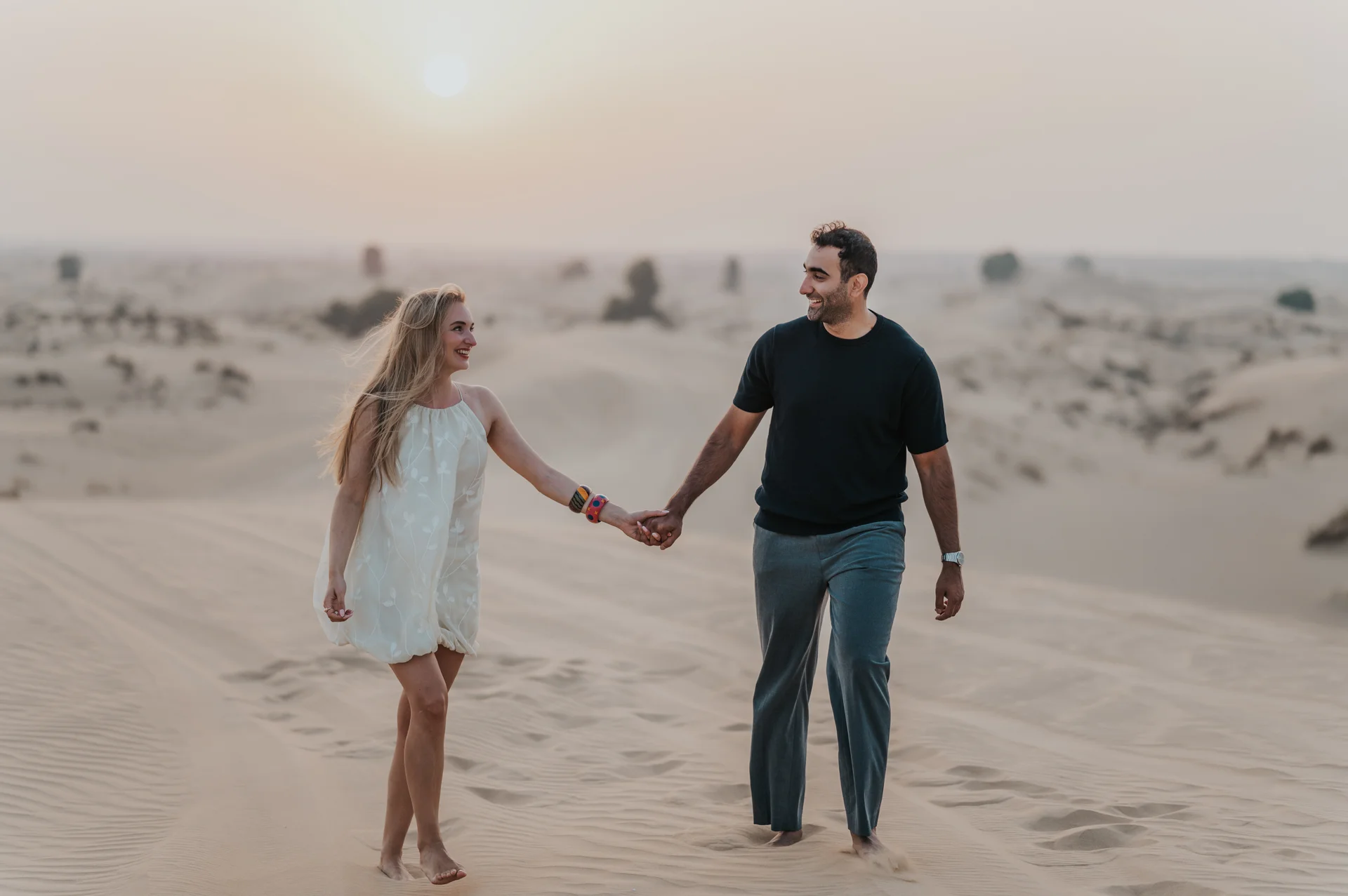 Dubai Photographer photographing a couple in the desert dunes